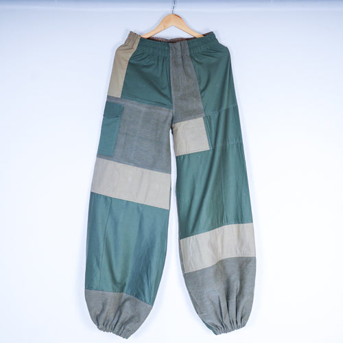 A pair of Camo-Stitch Joggers with quilted details, featuring patchwork patterns in green and beige tones.